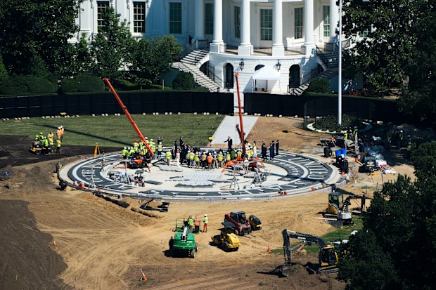 Donald Trump speaks on the South Lawn of the White House at the construction site of the new helicopter landing zone.