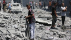 A Palestinian child searches for usable items among the rubble of destroyed buildings in Gaza City. 