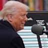 Donald Trump lovingly cuddled a big poster detailing the tariff vengeance he was about to unleash.