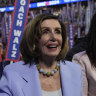 Representative Nancy Pelosi holds a sign during the Democratic National Convention.
