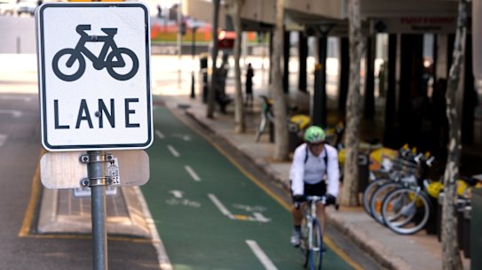 A cyclist rides his bike on a bike lane in Brisbane.