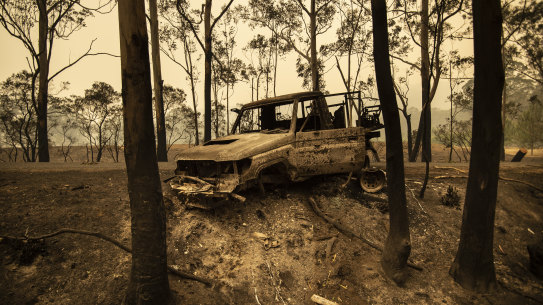 A National Parks and Wildlife Service LandCruiser lies burnt at Tallowa Dam Road in Kangaroo Valley. 