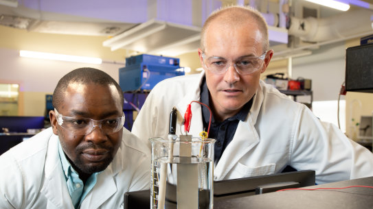 PhD researcher Olawale Oloye (left) and Professor Anthony O’Mullane have developed a method to capture carbon for use in cement.