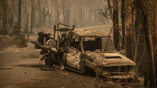 A NPWS firefighting Landcruiser lies burnt on Tallowa Dam Rd in Kangaroo Valley. It crashed after hitting a fallen tree on saturday when the Currowan fire impacted the area while the crew sheltered in a nearby dam. 