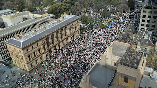 Thousands of school students and workers arrive at Treasury gardens for the beginning of Melbourne's climate strike.