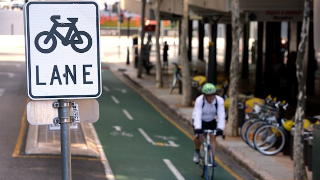 A cyclist rides his bike on a bike lane in Brisbane.