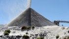 Lithium ore falls onto a stockpile at a Pilbara Minerals project in Port Hedland.