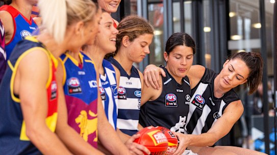 AFLW players attend a launch last year of a four-year broadcast deal with Foxtel and Seven.