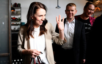 Jacinda Ardern waves to supporters at an Auckland cafe on Sunday morning, after her election victory.