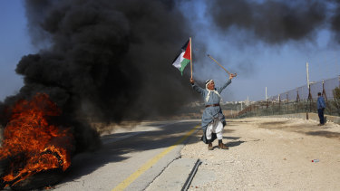 A Palestinian protests Israeli settlements  in the outskirts of the village Kafr Thulth near the West Bank town of Qalqilya, on Saturday.  Israel has ordered another 800 Jewish homes be built in the West Bank.