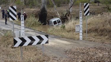Police on the scene at Whiteheads creek in Seymour, where a man drowned after driving his car into flood waters. 
