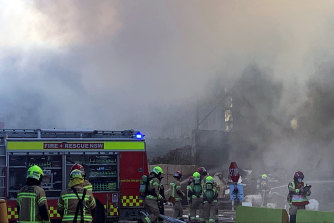 One hundred firefighters, 20 firetrucks and an excavator are at the Rockdale warehouse fire as smoke chokes surrounding streets.