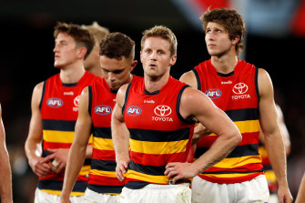 Rory Sloane and the Crows leave the field after the game.