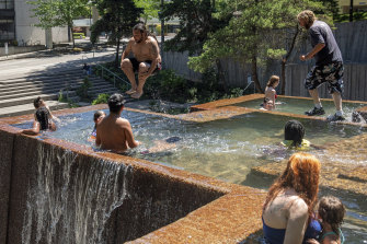 People cool off at Keller Fountain Park in Portland, Oregon, US, on Sunday.