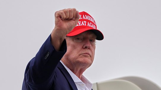 President Donald Trump gestures as he boards Air Force One on Sunday.