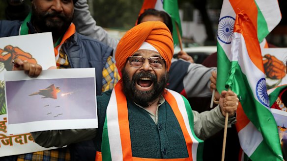 A man shouts slogans in support of India and against Pakistan as he celebrates reports of Indian aircraft bombing Pakistan territory.