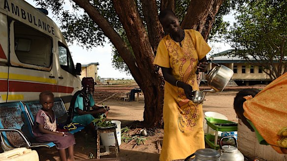 A woman prepares coffee at her stand at the Bentiu hospital in Bentiu, Unity State, South Sudan. 