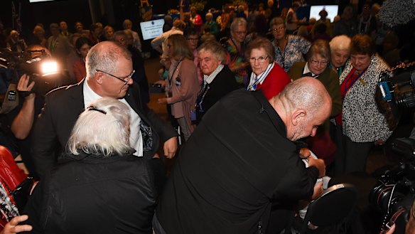 The protester is apprehended by the PM's security team after she threw an egg at him.