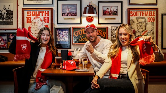 Swans fans Sophie Morris, Zac Chapman and Chelsea Schultz enjoy a drink at the Rising Sun ahead of their side’s preliminary final clash with Port Adelaide.