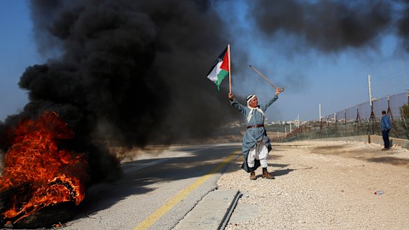 A Palestinian protests Israeli settlements  in the outskirts of the village Kafr Thulth near the West Bank town of Qalqilya, on Saturday.  Israel has ordered another 800 Jewish homes be built in the West Bank.