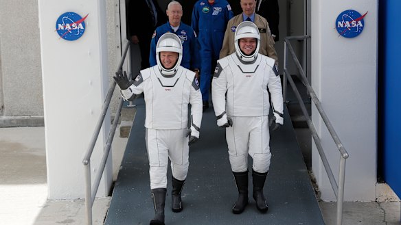 NASA astronauts Douglas Hurley, left, and Robert Behnken wave as they make their their way to Pad 39-A, at the Kennedy Space Centre in Cape Canaveral, Florida. 
