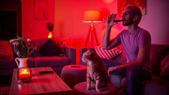 Drinking more while in isolation: Matthew Sherwood in his Rose Bay apartment with his cat Archie.