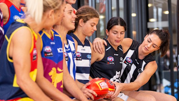 AFLW players attend a launch last year of a four-year broadcast deal with Foxtel and Seven.