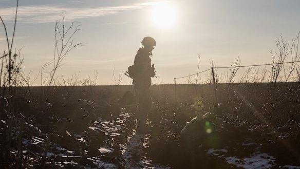 A Ukrainian soldier walks on the line of separation from pro-Russian rebels, in Mariupol, Donetsk region, Ukraine.