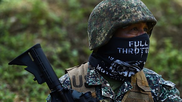 A Filipino marine pauses during firing during urban combat shooting at a firing range in Palawan, the Philippines.