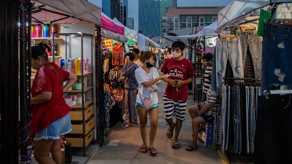 People browse the newly reopened Rot Fai Market in Bangkok, Thailand.