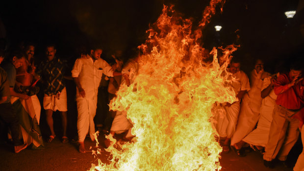 Opposition Congress party activists burn an effigy of Chief Minister Pinarayi Vijayan reacting to reports of two women of menstruating age entering the Sabarimala temple, one of the world's largest Hindu pilgrimage sites, in Thiruvananthapuram, Kerala, India.