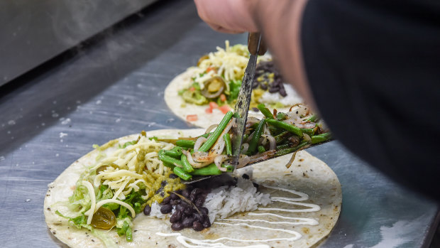 Food is prepared for delivery in a dark kitchen. 