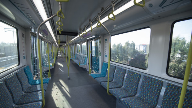 A single-deck metro train speeds along the line from Rouse Hill.