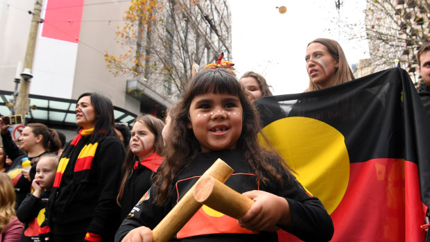 Some of the hundreds of people took part in a NAIDOC Week march in Melbourne on Friday to celebrate Aboriginal and Torres Strait Islander culture.