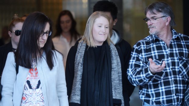 Courtney Khannara (centre) leaves court with supporters after giving evidence on Wednesday.