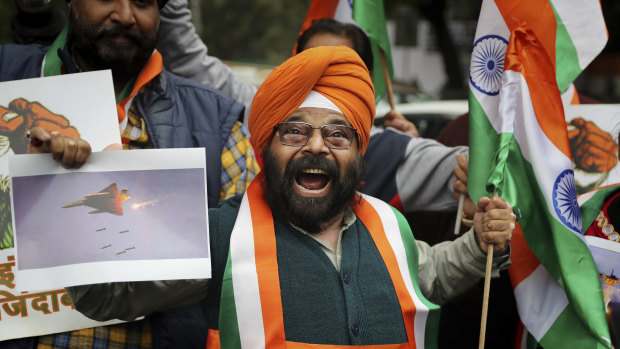 A man shouts slogans in support of India and against Pakistan as he celebrates reports of Indian aircraft bombing Pakistan territory.