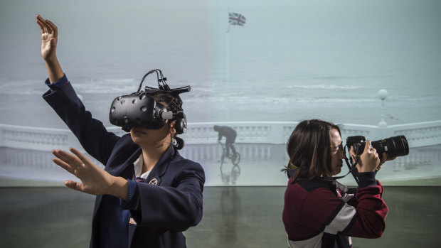 Erika Strehler (left) and Bonnie Huang test run the virtual reality of Shawn Gladwell's art before this Sunday's GENEXT adult-free art evening at the MCA.  