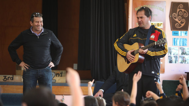 Loves a sing-song: Wayne Smith and then-Chiefs coach Dave Rennie talk to school students in 2012.