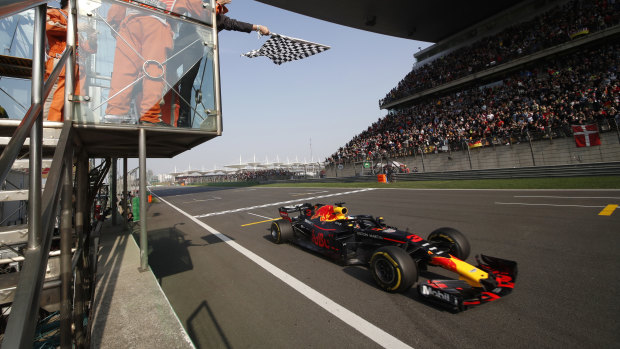 Shanghai delight: Ricciardo takes the checkered flag.