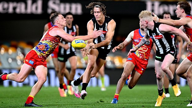 Darcy Moore of the Magpies gets a handball away during the round 17 AFL match between the Collingwood Magpies and the Gold Coast Suns at the Gabba on September 14.