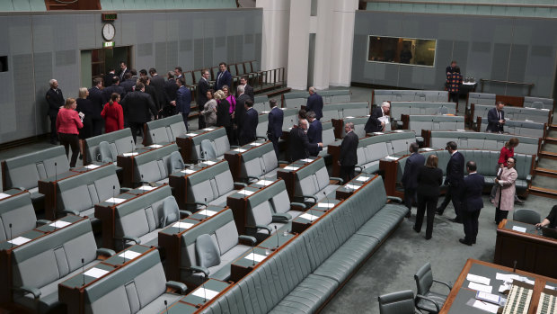 MPs exit the House of Representatives after it was adjourned.