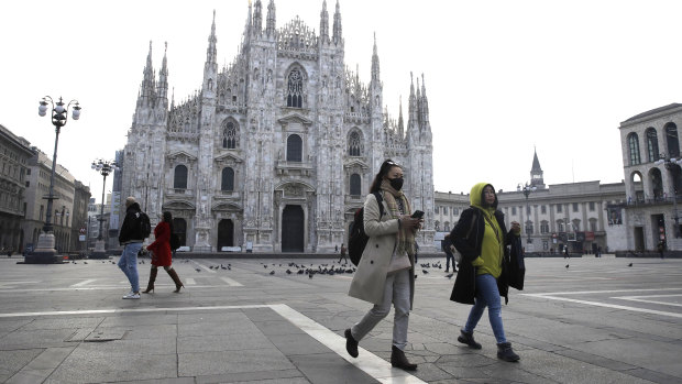 The nearly deserted piazza outside the Duomo gothic cathedral in Milan, Italy. 