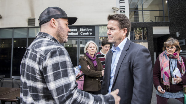 Kevin Anderson, Minister for Better Regulation and Innovation, speaking with an affected resident.