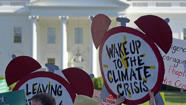 Demonstrators gather outside the White House to protest against President Donald Trump's decision to withdraw from the Paris climate change accord.