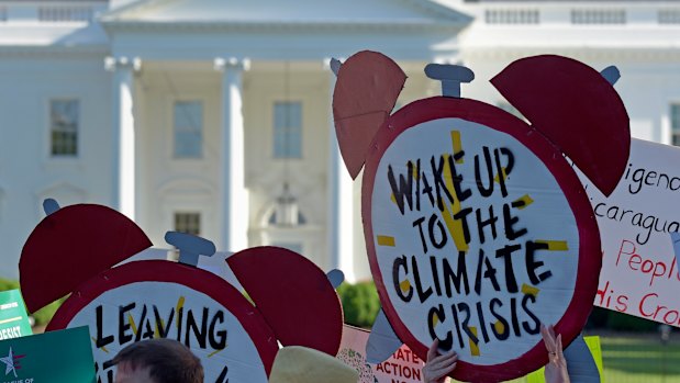 Demonstrators gather outside the White House to protest against President Donald Trump's decision to withdraw from the Paris climate change accord.