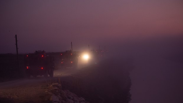 Turkish armoured vehicles prepare to cross the border into Syria in Akcakale, Turkey. 