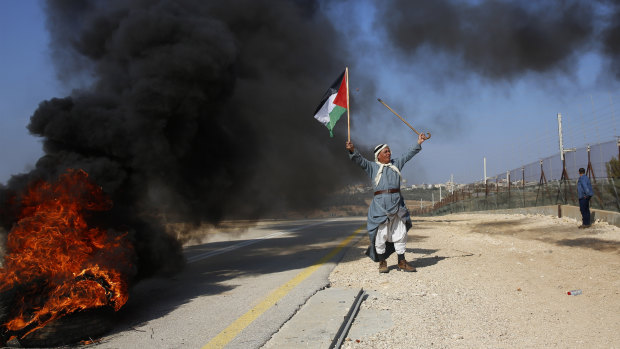 A Palestinian protests Israeli settlements  in the outskirts of the village Kafr Thulth near the West Bank town of Qalqilya, on Saturday.  Israel has ordered another 800 Jewish homes be built in the West Bank.