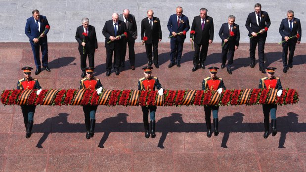 Putin takes part in the flower-laying ceremony at the Tomb of the Unknown Soldier in Alexander Garden.