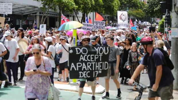 People march through Brisbane’s CBD from King George Square to Parliament House and One William Street in protest of the Queensland government’s vaccine mandates.
