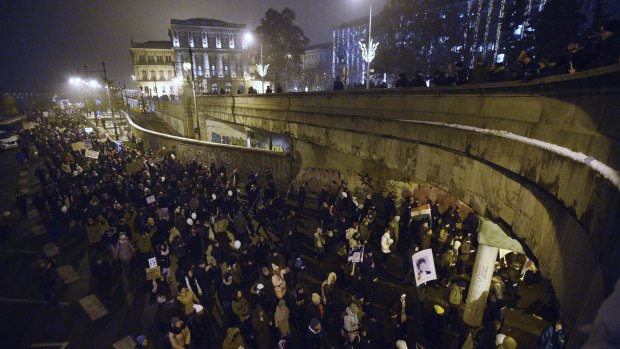 Supporters of the oppositional satirical Hungarian Two-tailed Dog Party march in the streets in Budapest, Hungary during their demonstration called "National All-Christmas Peace March" on Friday, Dec. 21, 2018. Tho